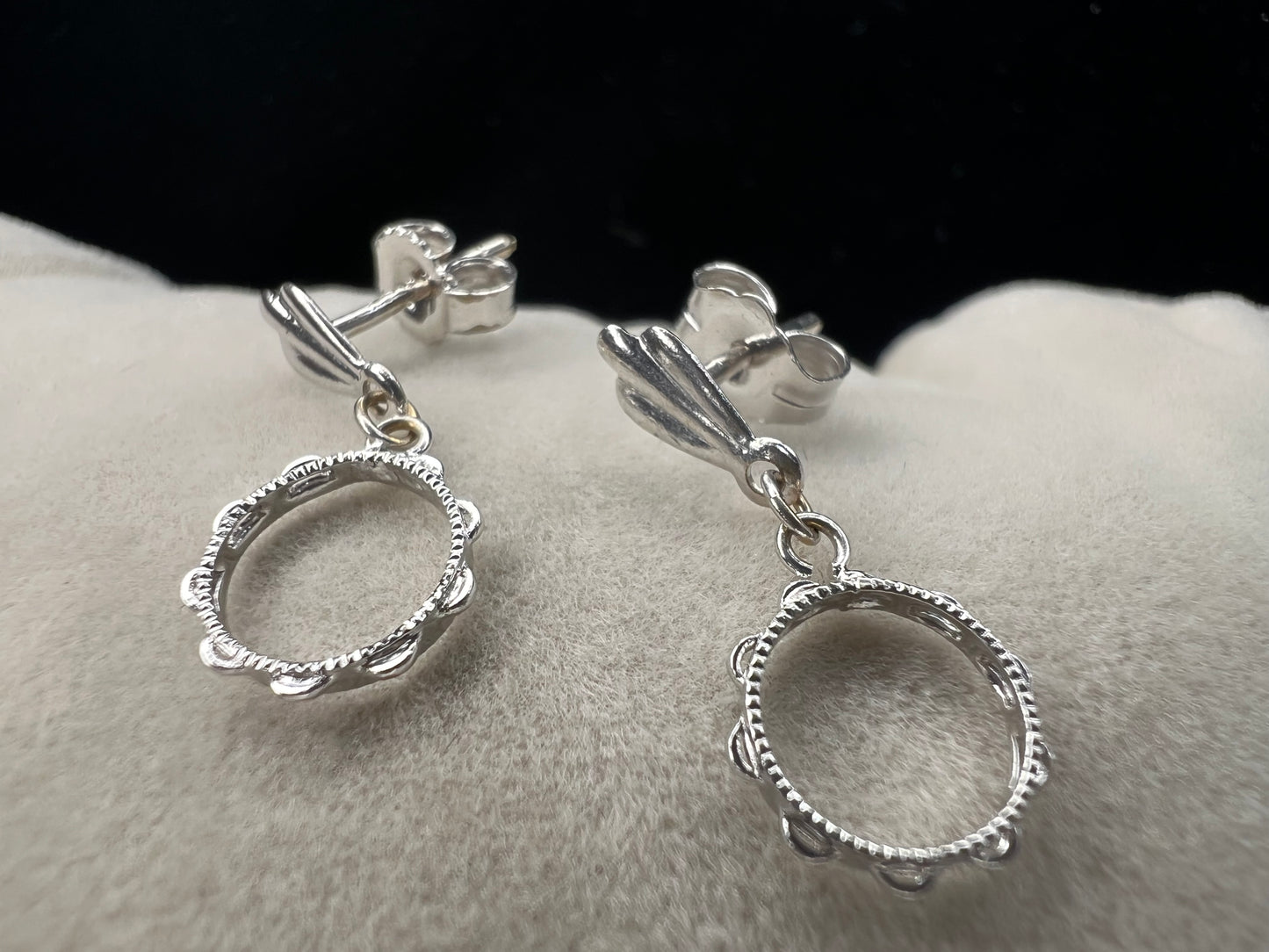 These earrings look like little tambourines. Crafted from 14 karat white gold, these would be perfect for any music lover.