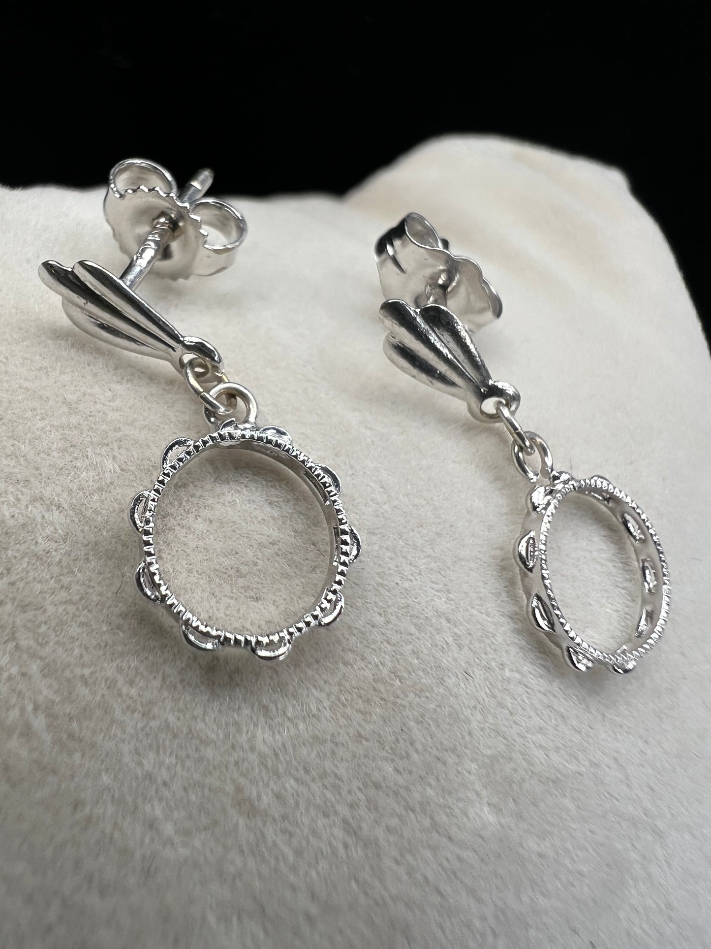 These earrings look like little tambourines. Crafted from 14 karat white gold, these would be perfect for any music lover.