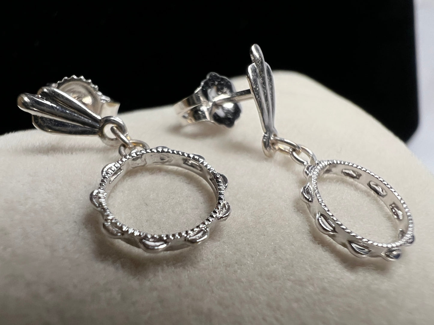 These earrings look like little tambourines. Crafted from 14 karat white gold, these would be perfect for any music lover.
