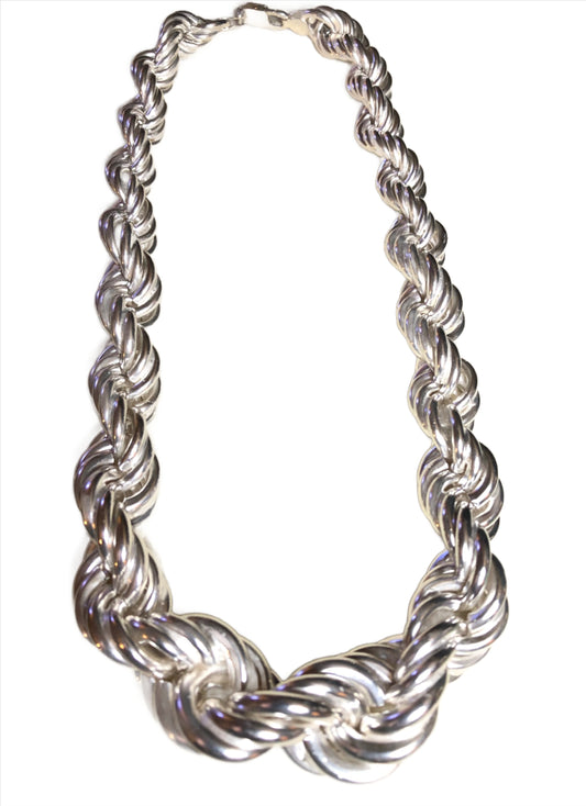 This sterling silver beauty boasts a large rope-style chain. The twisting links are largest front and center, and gradually become smaller until they join at the clasp.