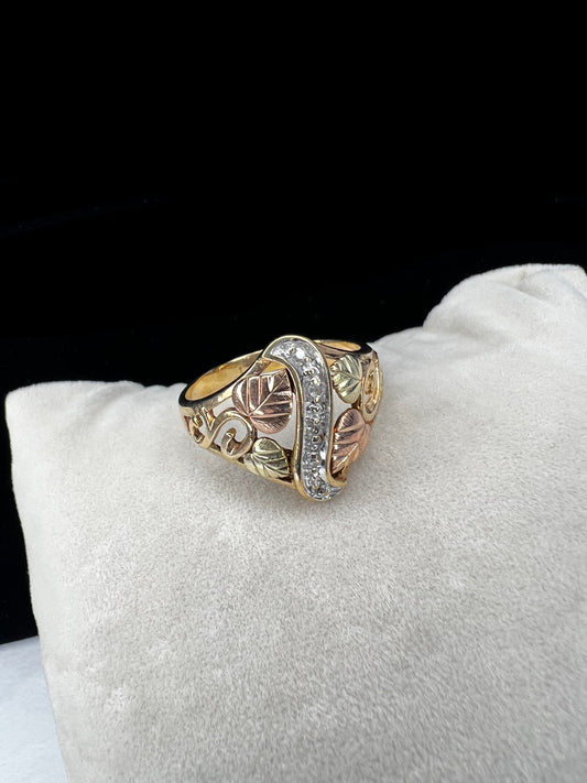 This ring features the signature look of Black Hills gold offered by Coleman Co. Made from 10 karat gold, it features a strip of small diamonds down the center.