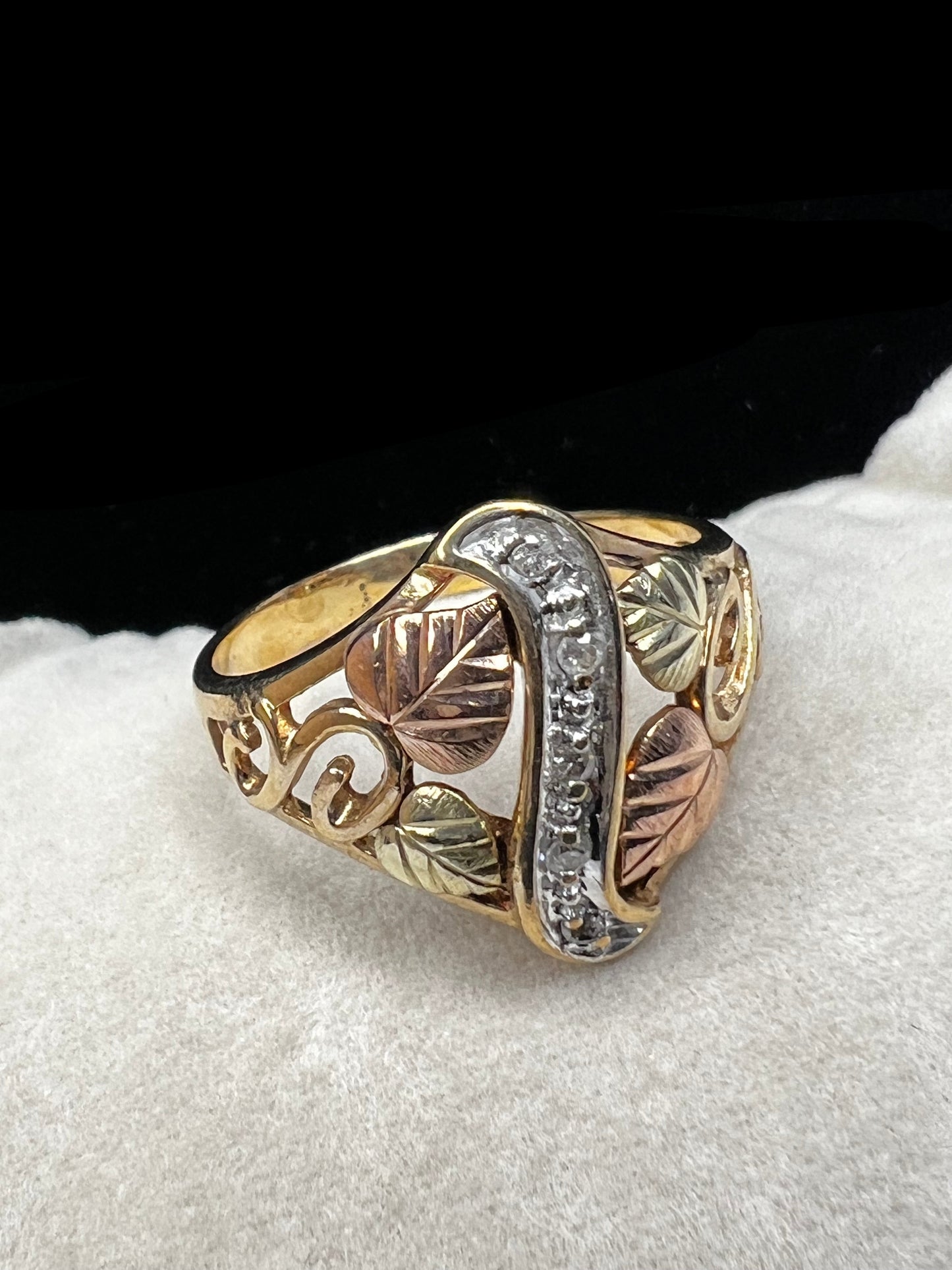 This ring features the signature look of Black Hills gold offered by Coleman Co. Made from 10 karat gold, it features a strip of small diamonds down the center.