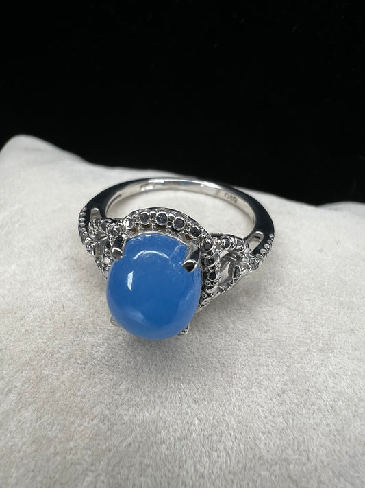 Elevate your style with this ring. Carefully crafted with a blue oval chalcedony in a well-made setting, this ring adds a touch of elegance to any outfit.
