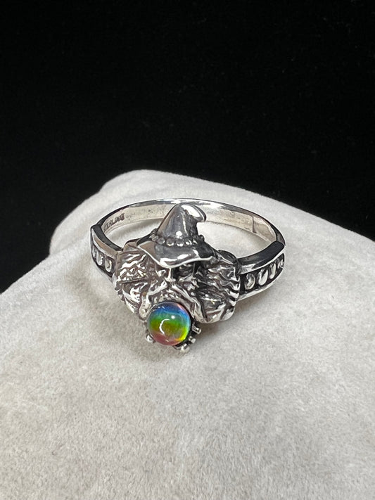 Add some magical mystique to your day with this sterling silver ring. It features a wizard and his crystal ball, which flashes multiple colors when moved in the light. This piece is marked with a copyright symbol and an S with a line through it (a dollar sign of sorts).