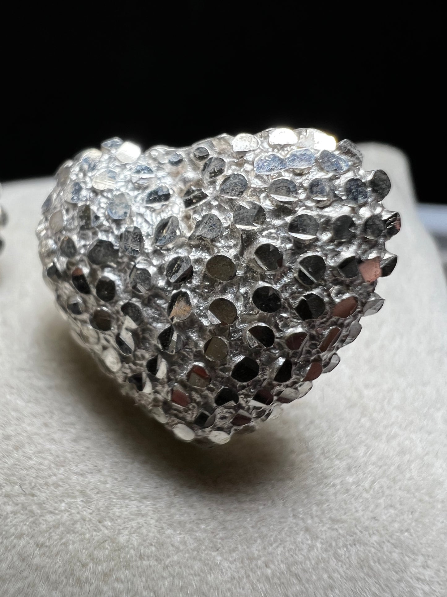 These bold heart-shaped sterling silver earrings are designed to look like a cluster of diamonds. It's a stunning look that will catch the light from every angle.