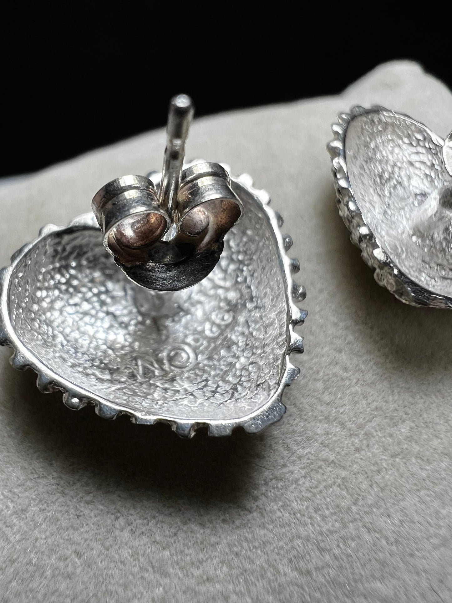 These bold heart-shaped sterling silver earrings are designed to look like a cluster of diamonds. It's a stunning look that will catch the light from every angle.