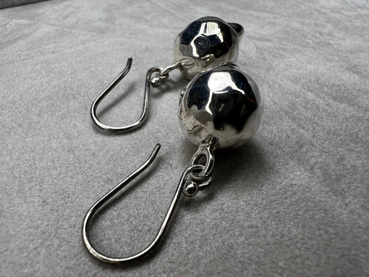These sterling silver earrings are designed to add movement and shimmer to any outfit.