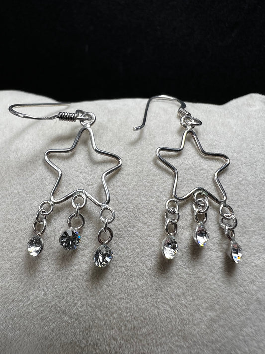 Shine like the star you are with these sterling silver earrings. They feature dangling crystals to catch the light and add extra movement to your outfit.