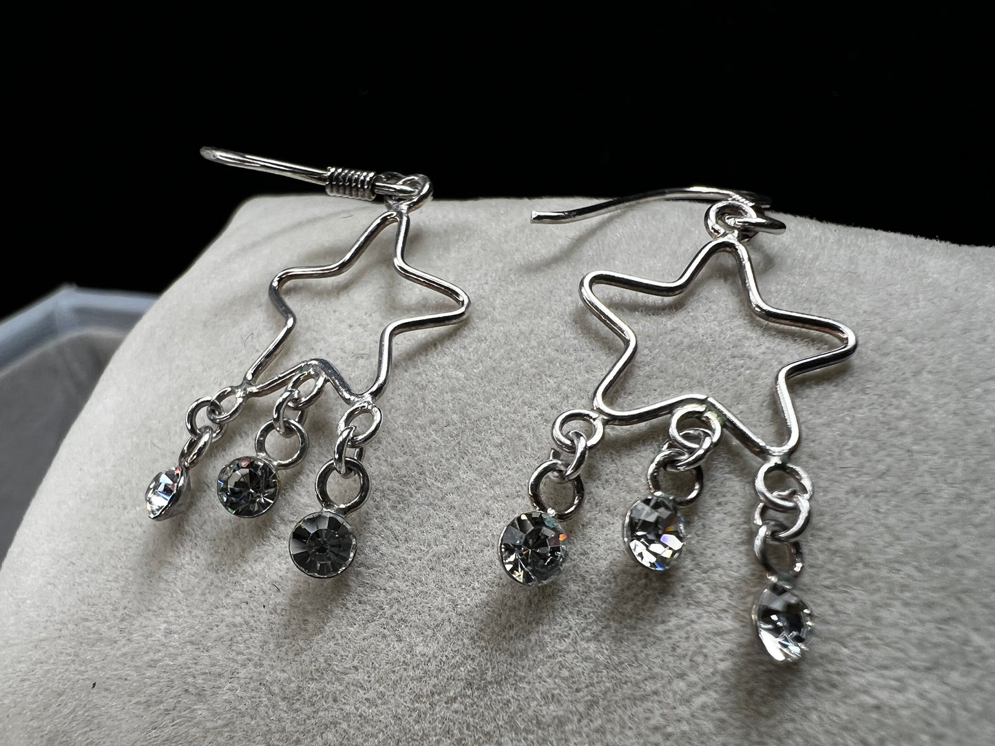 Shine like the star you are with these sterling silver earrings. They feature dangling crystals to catch the light and add extra movement to your outfit.