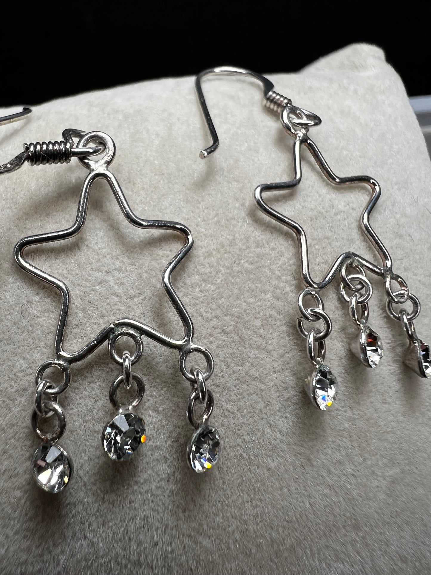 Shine like the star you are with these sterling silver earrings. They feature dangling crystals to catch the light and add extra movement to your outfit.