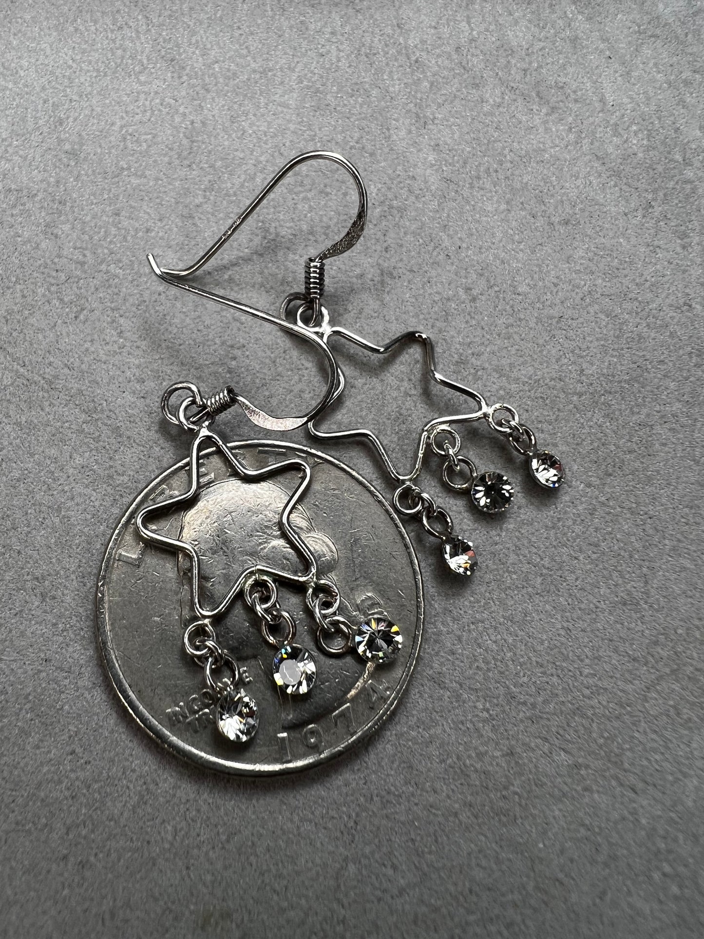 Shine like the star you are with these sterling silver earrings. They feature dangling crystals to catch the light and add extra movement to your outfit.
