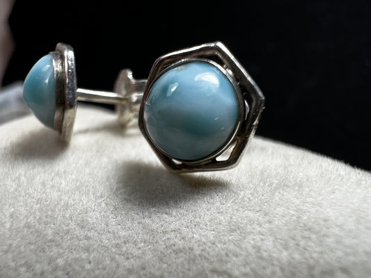 These sterling silver earrings feature natural larimar cabochons from the Dominican Republic set in a hexagon bezel, perfect for a touch of Caribbean charm.
