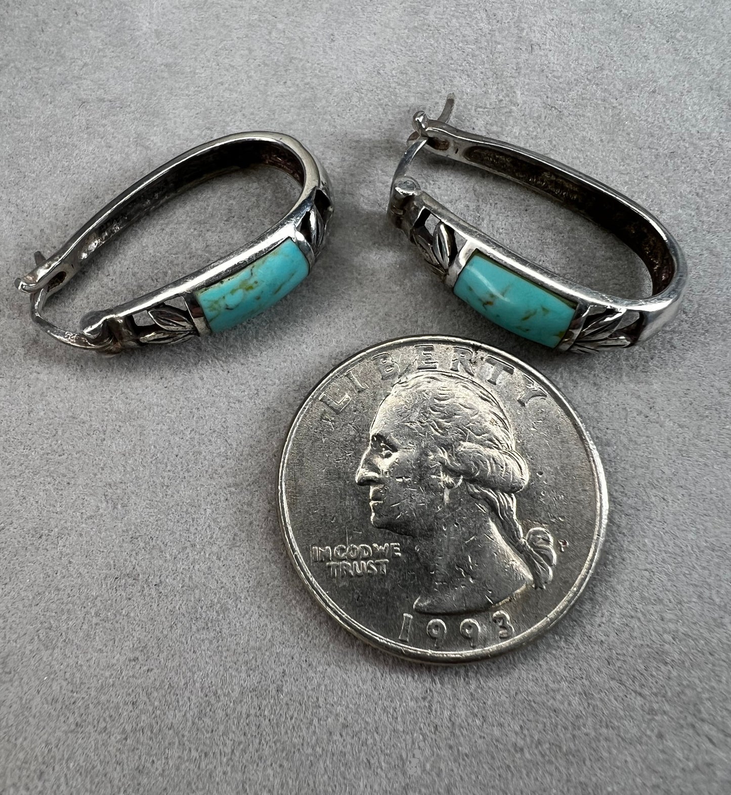 These vintage sterling silver earrings feature an openwork design accented with turquoise stones, offering a timeless vintage look.