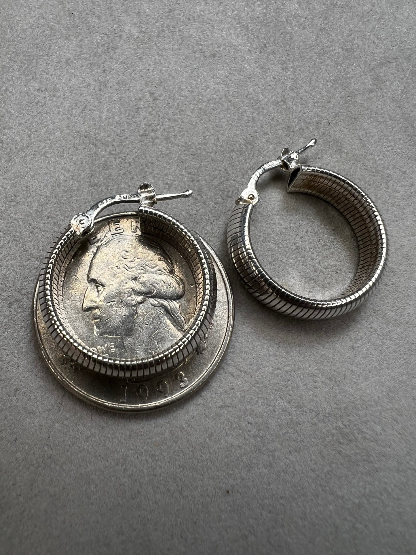 These sterling silver earrings feature a bold, domed design accented by horizontal ridges that catch the light beautifully.