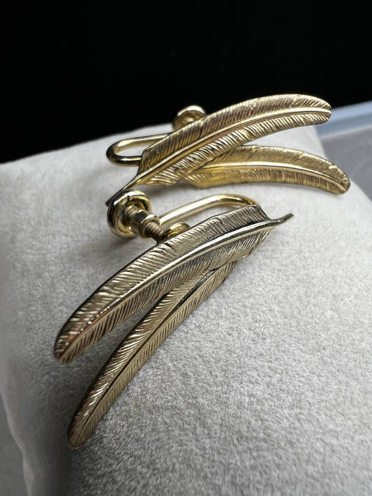 These vintage gold-filled earrings each feature two detailed feathers, offering a unique touch to your style.