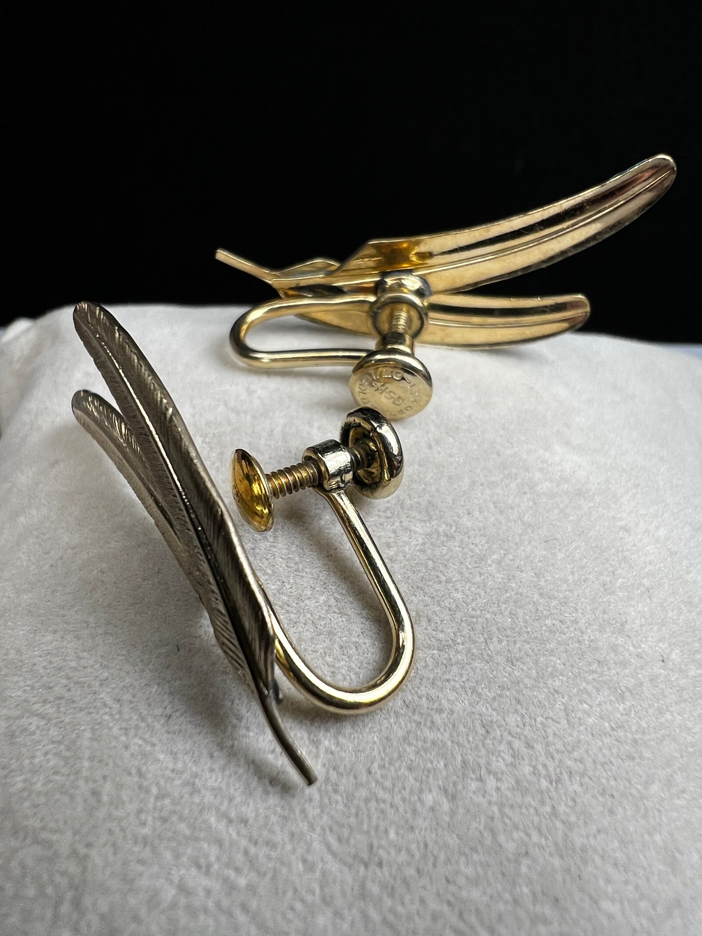 These vintage gold-filled earrings each feature two detailed feathers, offering a unique touch to your style.