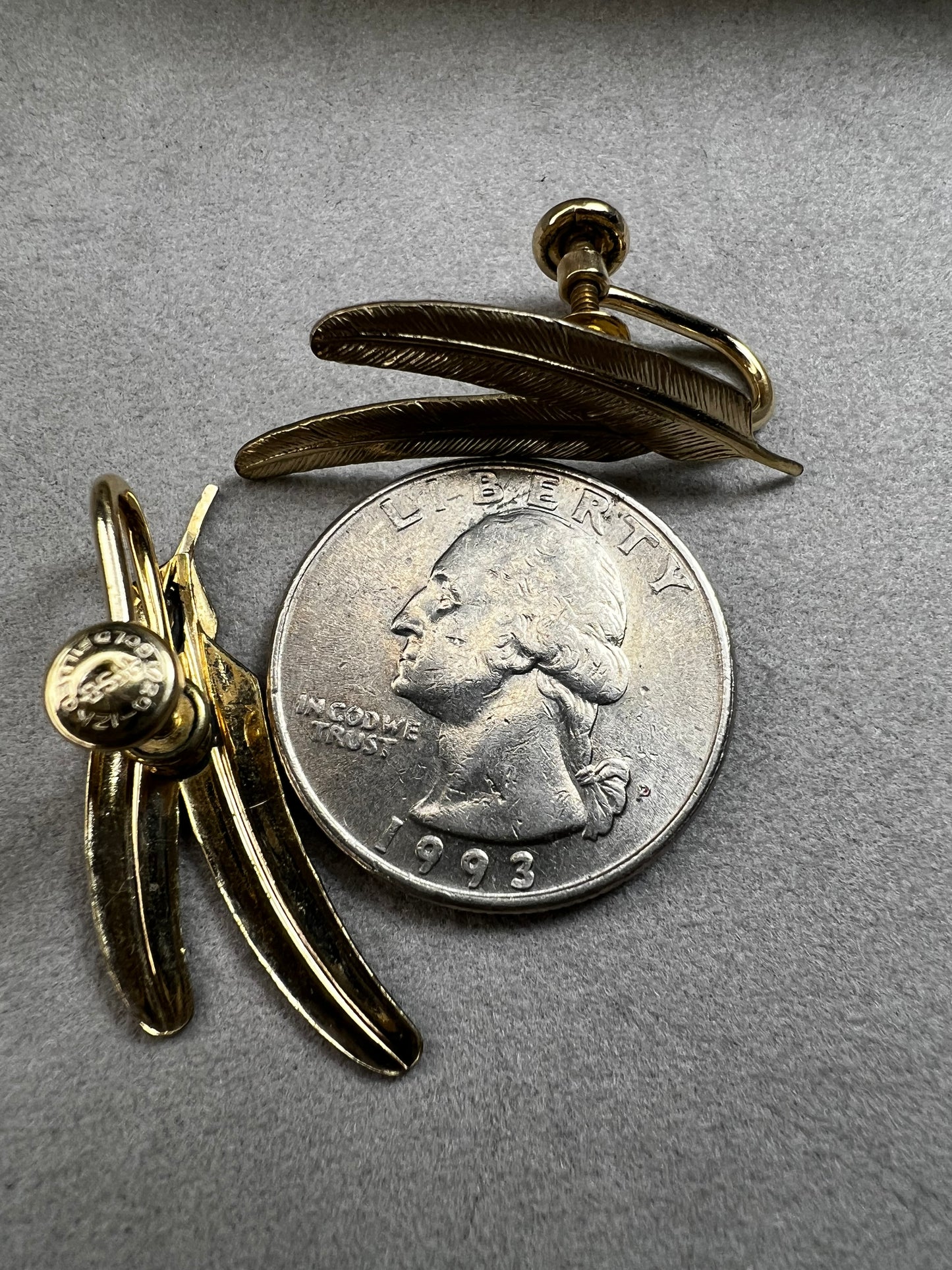 These vintage gold-filled earrings each feature two detailed feathers, offering a unique touch to your style.