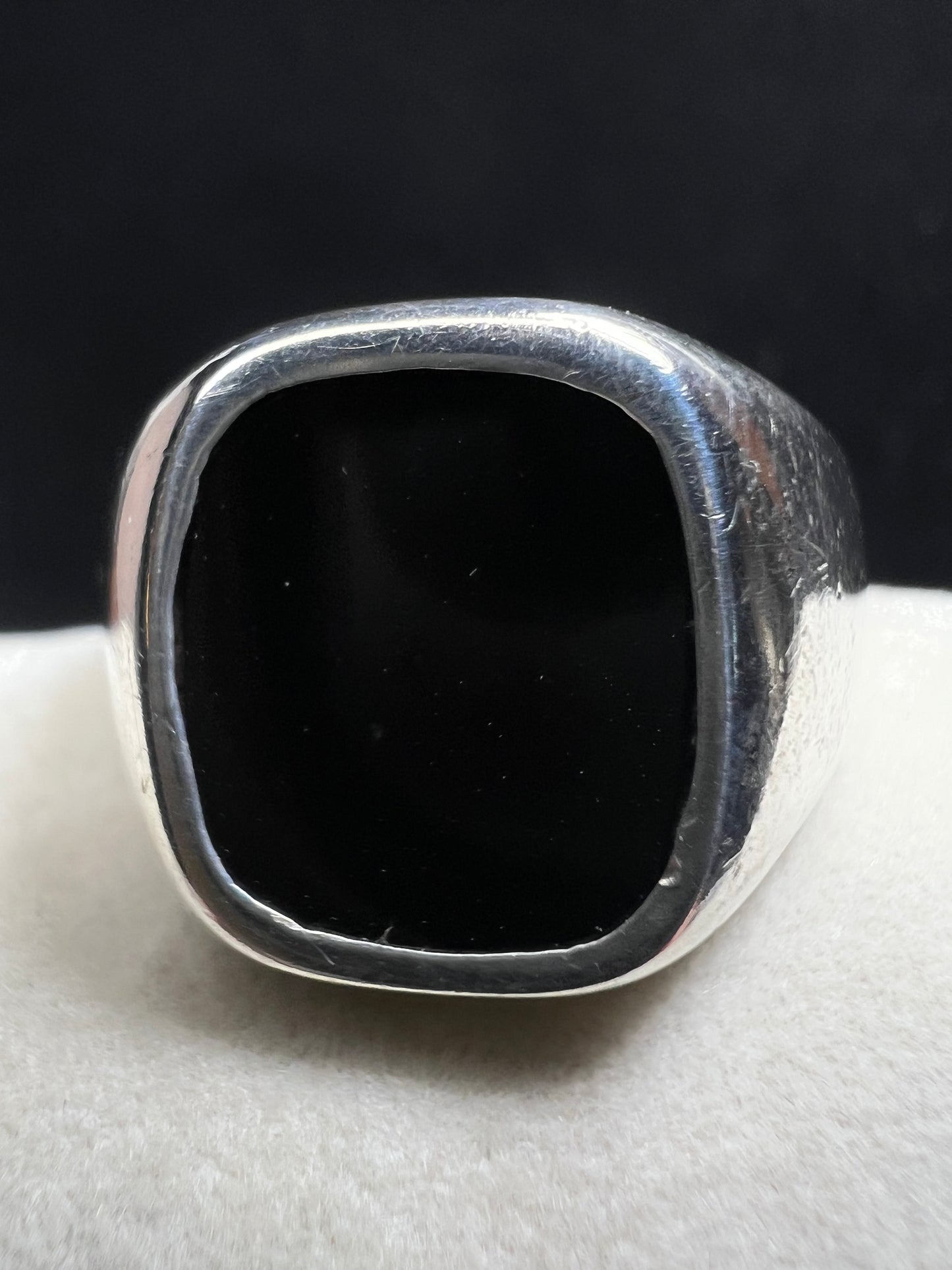 This vintage Avon ring combines sterling silver craftsmanship with a bold onyx centerpiece, designed to make a distinctive statement. Sized at 12.5, its unisex design suits both men and women seeking a timeless accessory with elegant presence.