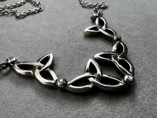This stunning sterling silver necklace from Keith Jack features an intricate Celtic-inspired pendant, symbolizing eternity and unity. The pendant opens up for a different look when desired. The design is accented with four genuine diamonds, adding just the right amount of sparkle and elegance.