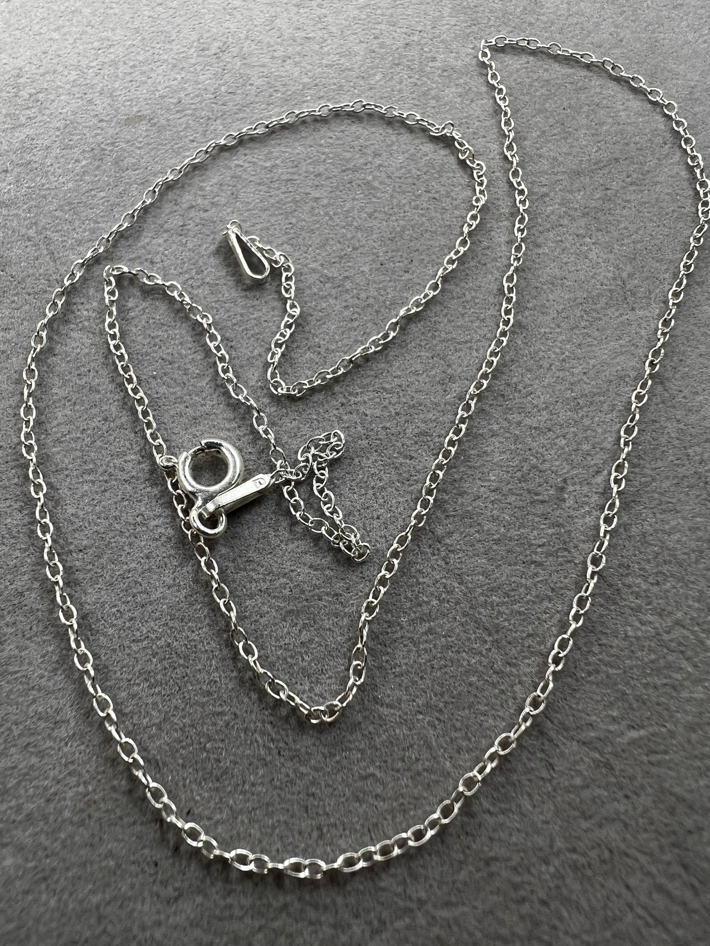 This petite sterling silver chain features a classic cable link, making it a versatile piece for your collection. It works on its own or layered with other necklaces -- or pair it with one of our small pendants.