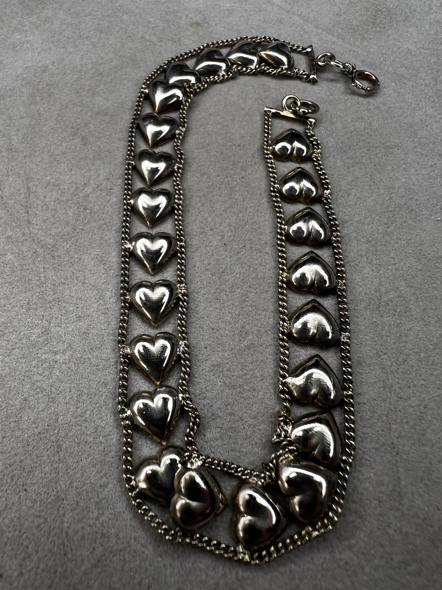 This vintage sterling silver chain and heart bracelet combines timeless durability with elegant design. Crafted from high-quality sterling silver, it offers a lasting piece that carries sentimental value.