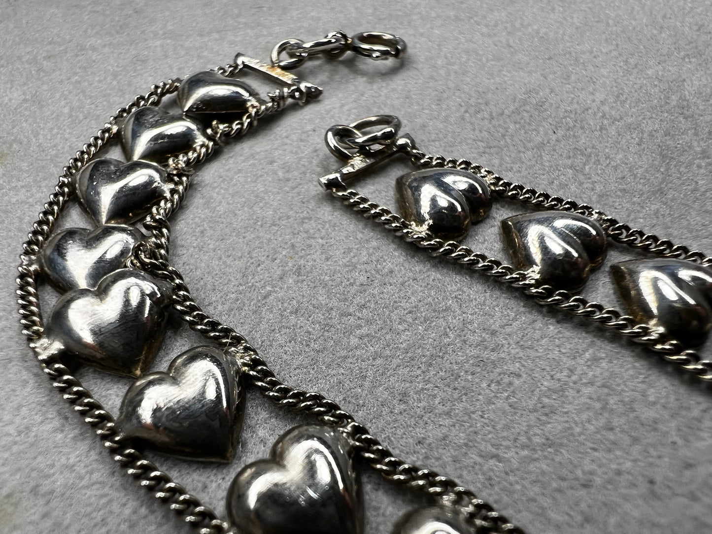 This vintage sterling silver chain and heart bracelet combines timeless durability with elegant design. Crafted from high-quality sterling silver, it offers a lasting piece that carries sentimental value.