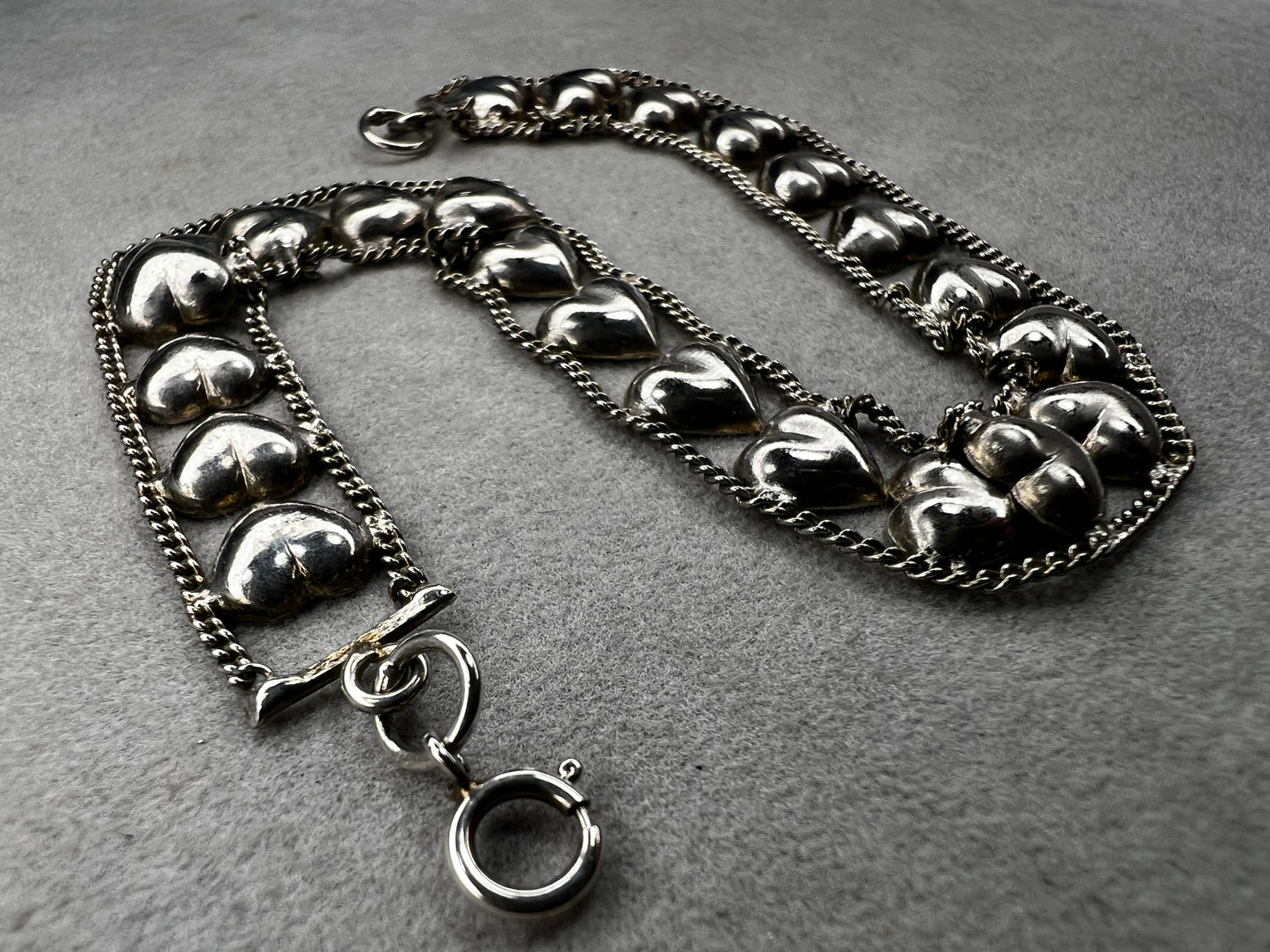 This vintage sterling silver chain and heart bracelet combines timeless durability with elegant design. Crafted from high-quality sterling silver, it offers a lasting piece that carries sentimental value.