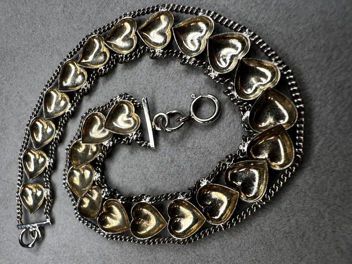 This vintage sterling silver chain and heart bracelet combines timeless durability with elegant design. Crafted from high-quality sterling silver, it offers a lasting piece that carries sentimental value.