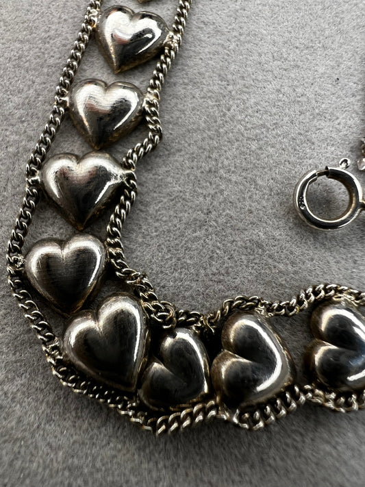 This vintage sterling silver chain and heart bracelet combines timeless durability with elegant design. Crafted from high-quality sterling silver, it offers a lasting piece that carries sentimental value.