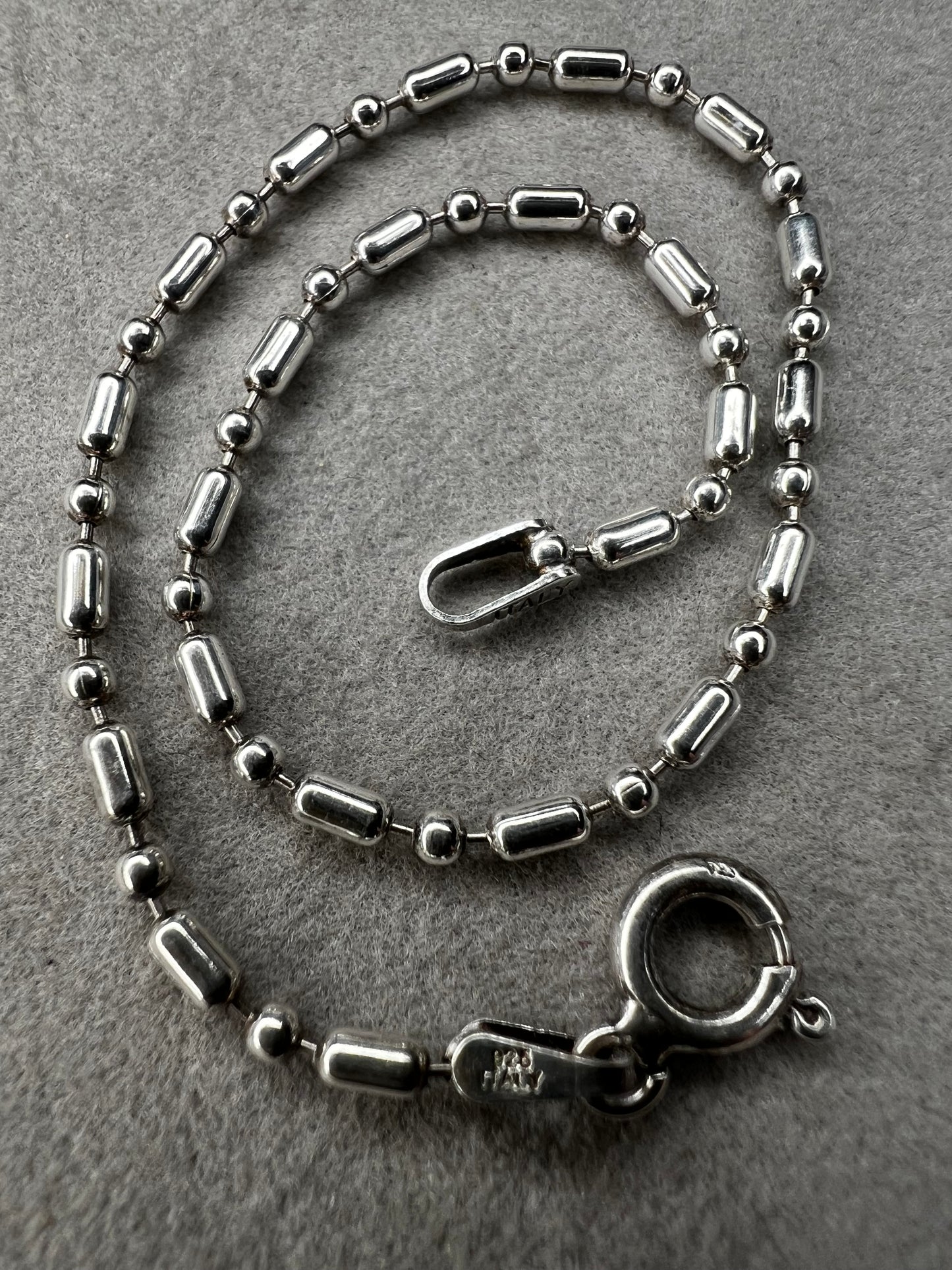 This sterling silver bracelet features an expertly crafted bead-and-tube link design, offering a distinctive alternative to traditional chains.
