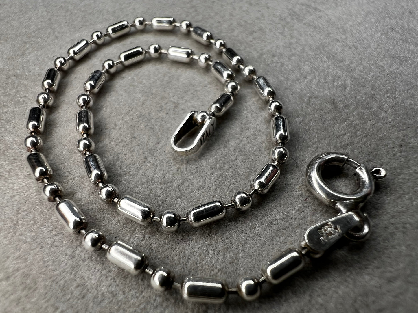 This sterling silver bracelet features an expertly crafted bead-and-tube link design, offering a distinctive alternative to traditional chains.