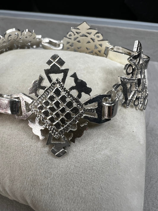 Crafted in sterling silver, this vintage bracelet features five ornate openwork panels. A timeless design that makes a striking statement.