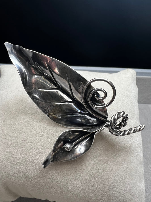 This sterling silver brooch features detailed craftsmanship that captures the beauty of nature -- perfect for anyone who loves the outdoors.