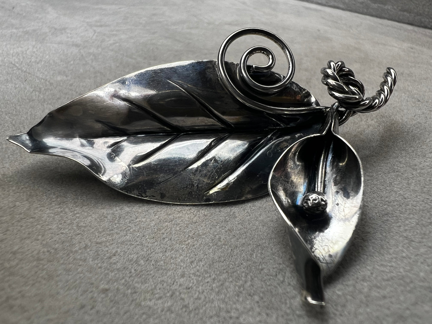 This sterling silver brooch features detailed craftsmanship that captures the beauty of nature -- perfect for anyone who loves the outdoors.