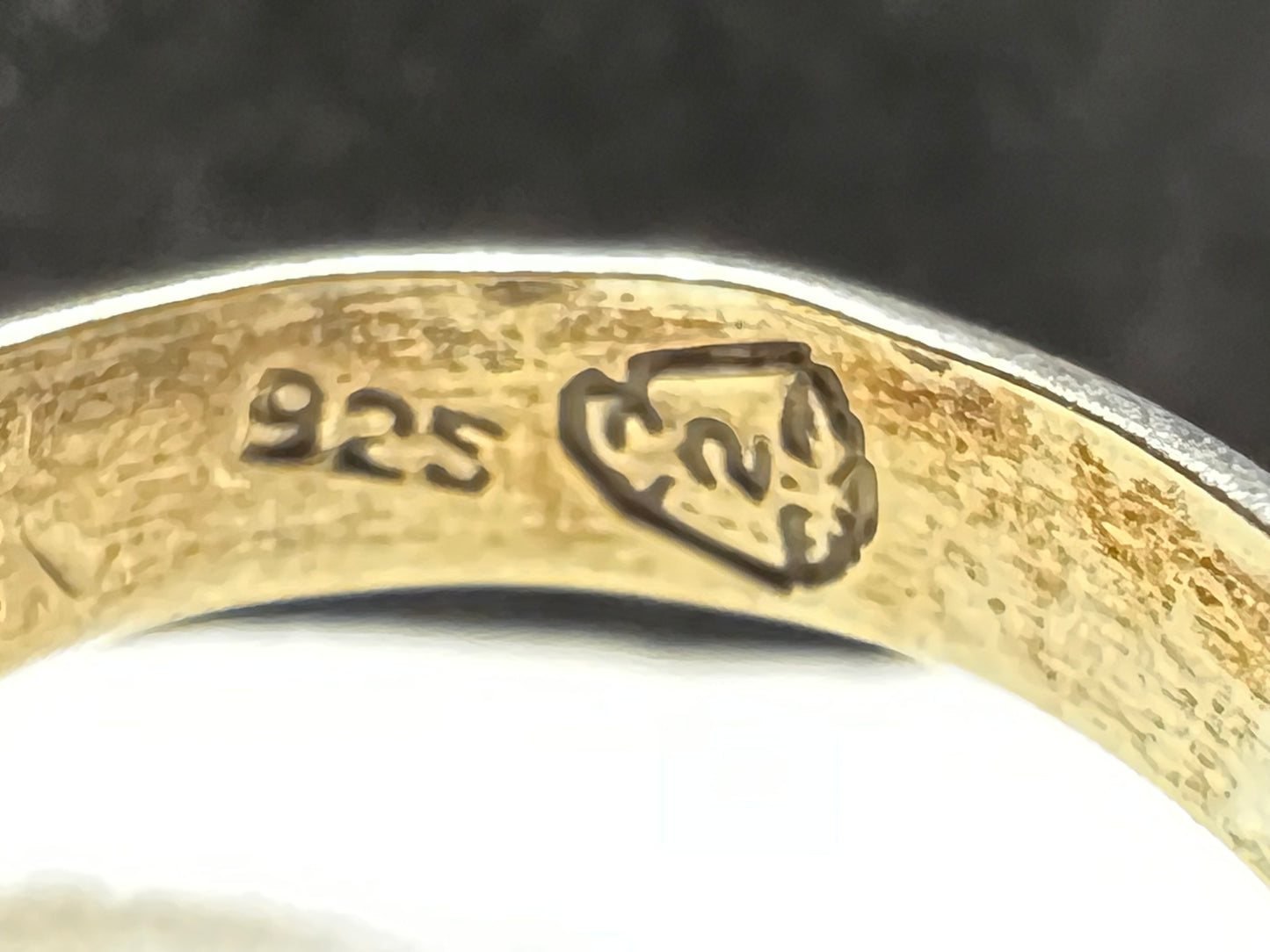 This vintage sterling silver ring features a meticulously cut tiger's eye stone, prized for its warm, reflective bands. The ring is signed Mexico, along with other maker marks.