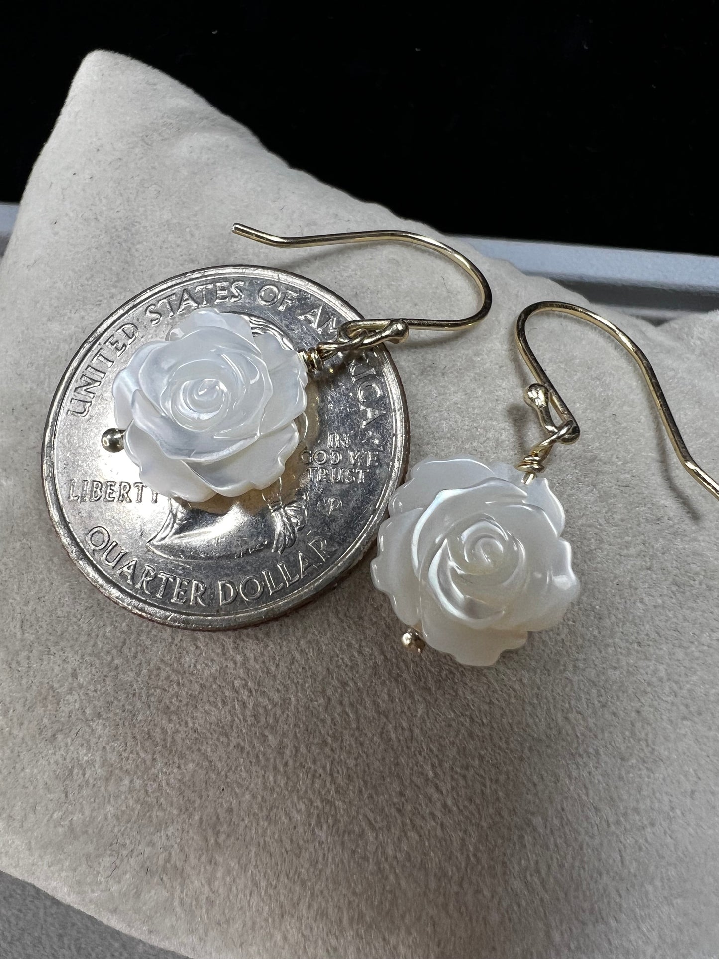 This stunning pair of earrings features a mother of pearl rose on each with gold washed sterling silver.