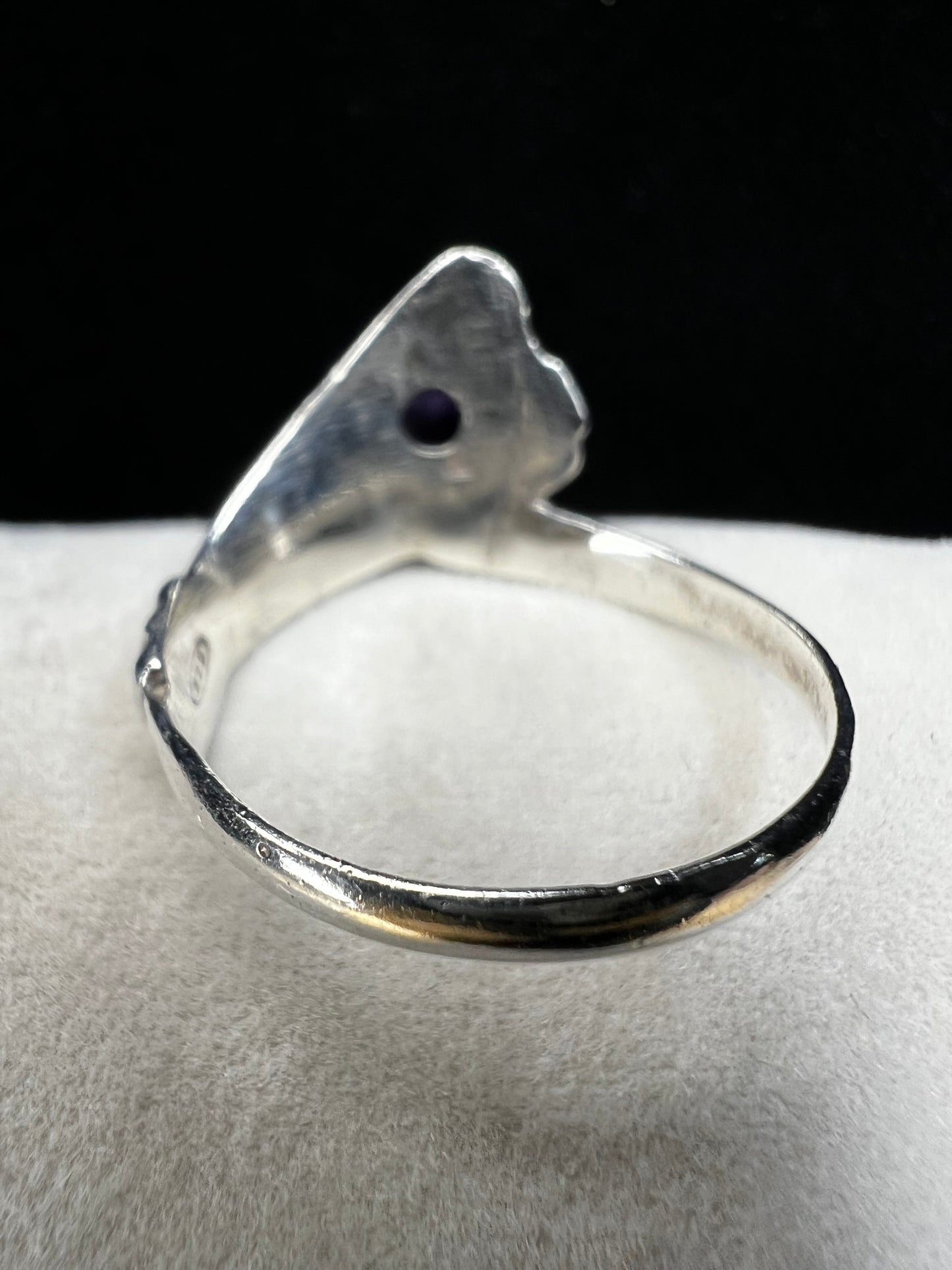 Add some individuality to your outfit with this sterling silver ring. Its unique design features an amethyst front and center.