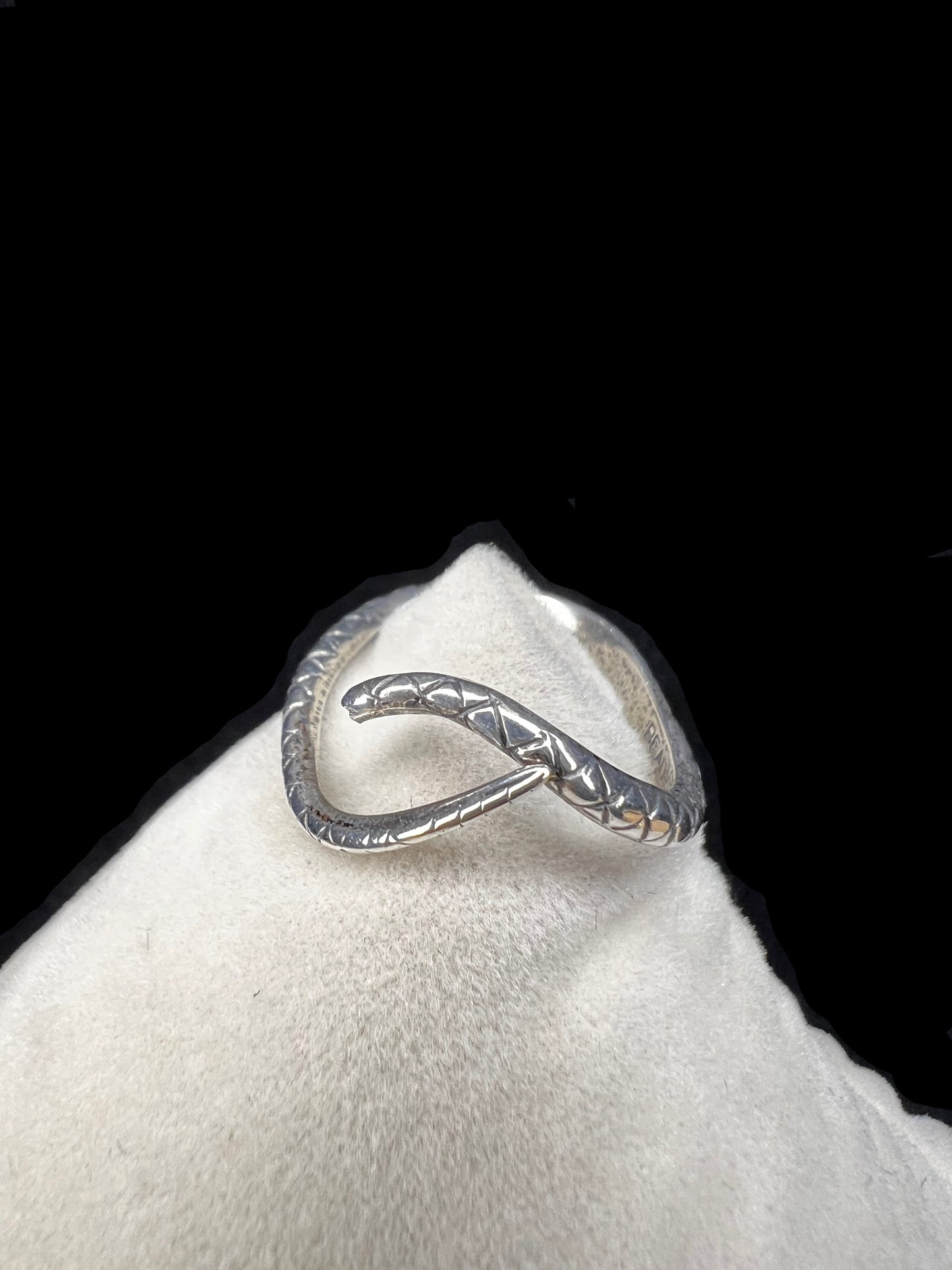 This Beau Sterling ring features a snake design that coils gracefully around your finger. This expertly detailed piece combines artistry and symbolism, offering a bold yet elegant accessory that will enhance any jewelry collection.