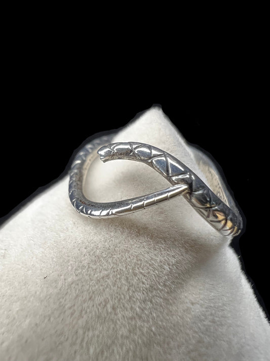 This Beau Sterling ring features a snake design that coils gracefully around your finger. This expertly detailed piece combines artistry and symbolism, offering a bold yet elegant accessory that will enhance any jewelry collection.
