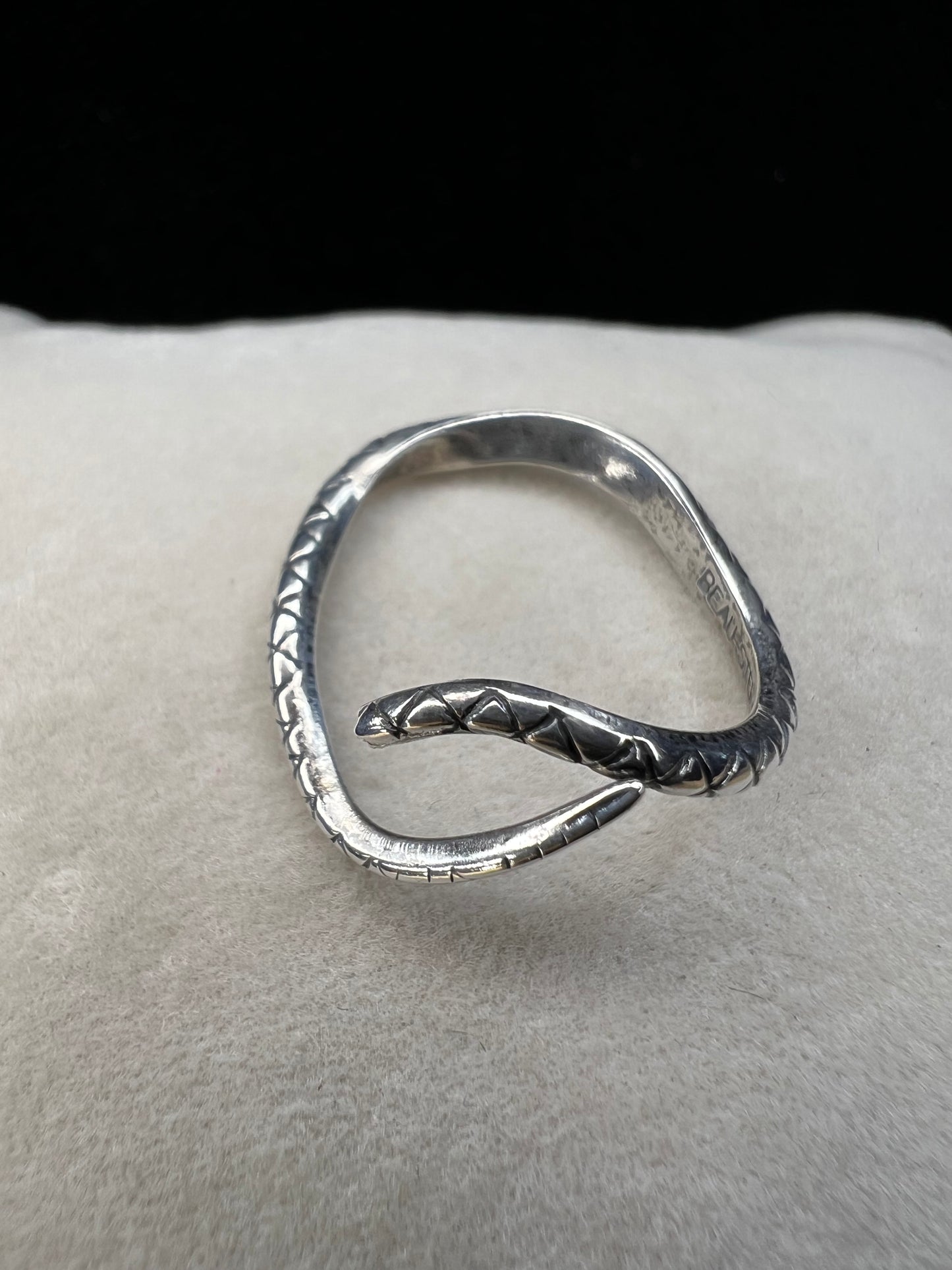 This Beau Sterling ring features a snake design that coils gracefully around your finger. This expertly detailed piece combines artistry and symbolism, offering a bold yet elegant accessory that will enhance any jewelry collection.