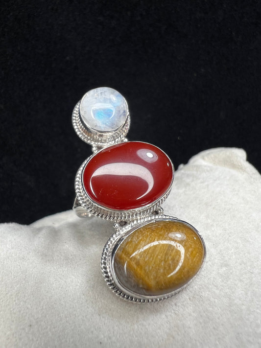This sterling silver ring features striking cabochons of tiger's eye, moonstone, and carnelian, creating a versatile accessory that pairs effortlessly with a variety of colors.