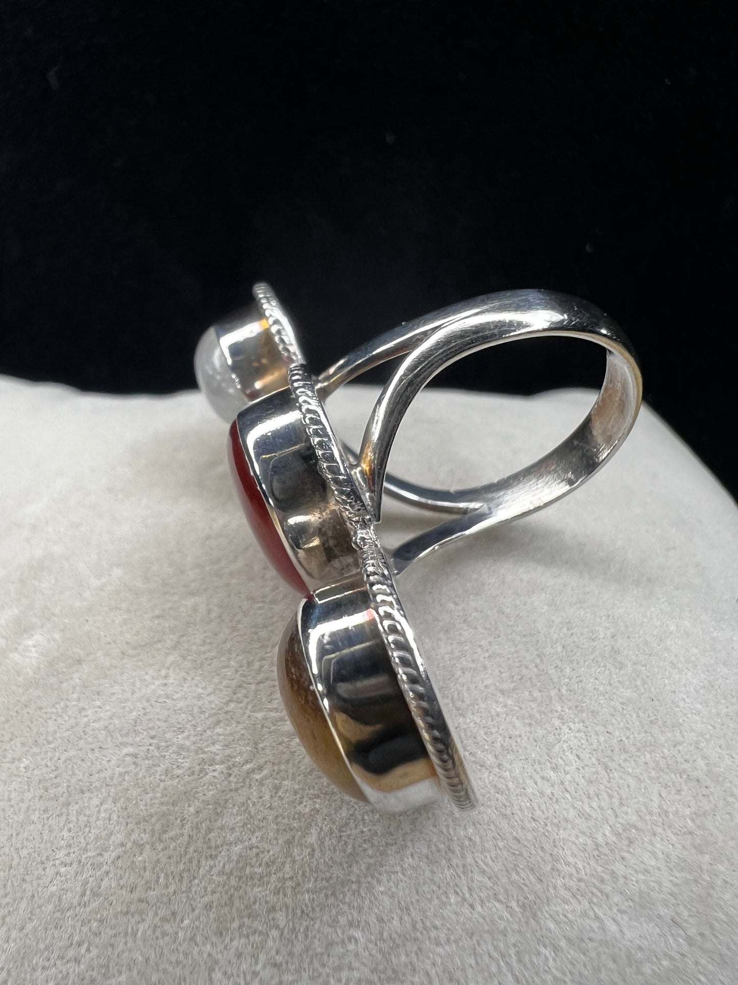 This sterling silver ring features striking cabochons of tiger's eye, moonstone, and carnelian, creating a versatile accessory that pairs effortlessly with a variety of colors.