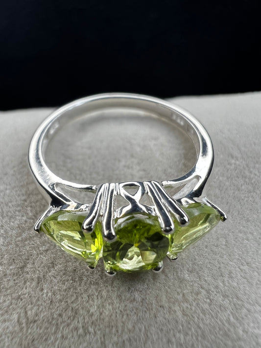 Three peridot stones front and center make this a special ring. Crafted from sterling silver, this piece is perfect when your outfit needs a spark. The cut, color and design of these stones will not disappoint.