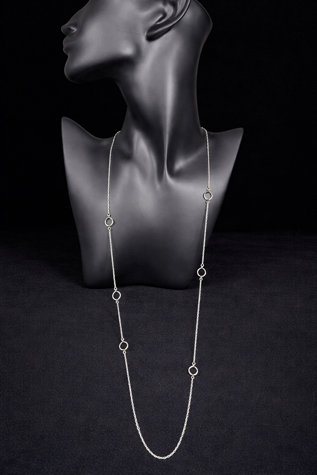 This long sterling silver necklace is designed with intermittent geometric links along the length of the chain. Two of those large links feature a small diamond for a touch of flash in the light. At 34 inches, this can be wrapped twice for a layered look, or it can be worn long. Made by Silpada.
