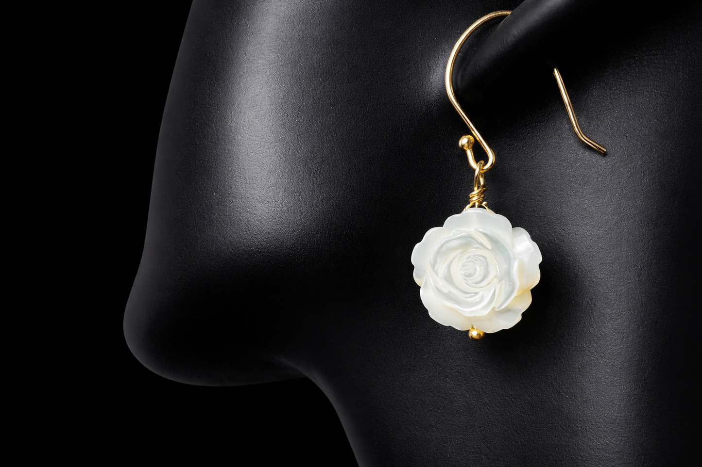 This stunning pair of earrings features a mother of pearl rose on each with gold washed sterling silver.