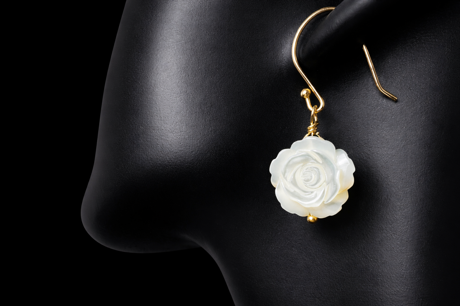 This stunning pair of earrings features a mother of pearl rose on each with gold washed sterling silver.