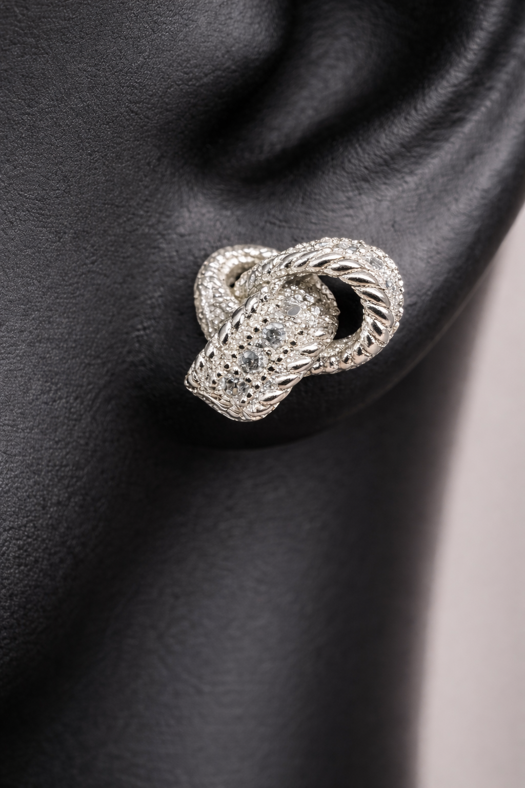 Sterling silver and diamond earrings. Perfect for a special event or just a night out. The diamonds are set along the knotted ribbon design, ready to catch just the right light for a little flash.