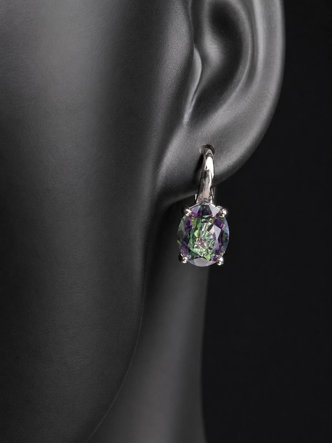 Elevate your everyday elegance with these stunning sterling silver mystic topaz earrings. Each piece showcases a radiant lab-created mystic topaz stone measuring 10 mm x 8 mm, displaying mesmerizing rainbow hues that catch the light beautifully. Crafted from genuine sterling silver, these earrings offer a perfect balance of sophistication and eye-catching sparkle.