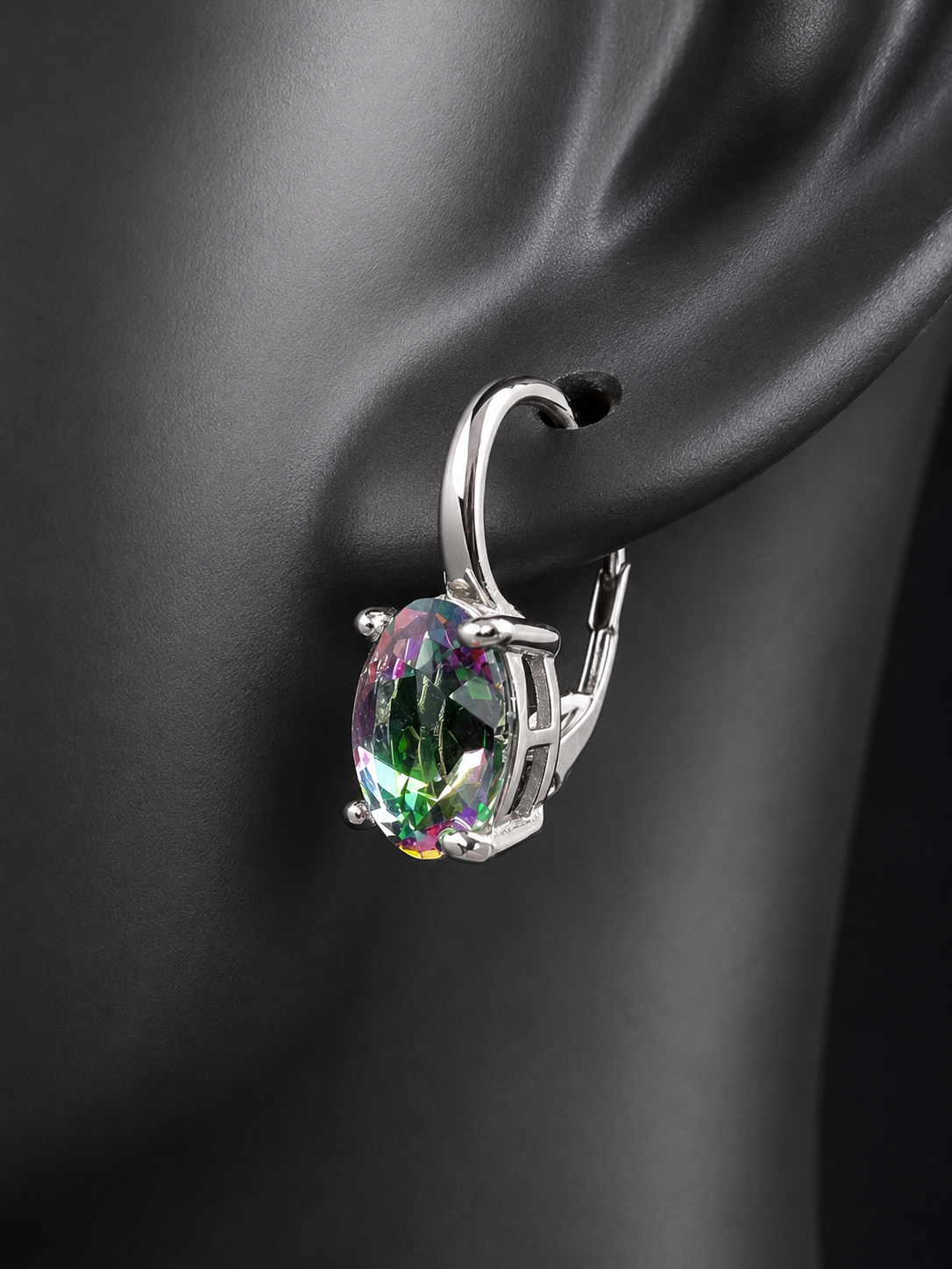 Elevate your everyday elegance with these stunning sterling silver mystic topaz earrings. Each piece showcases a radiant lab-created mystic topaz stone measuring 10 mm x 8 mm, displaying mesmerizing rainbow hues that catch the light beautifully. Crafted from genuine sterling silver, these earrings offer a perfect balance of sophistication and eye-catching sparkle.