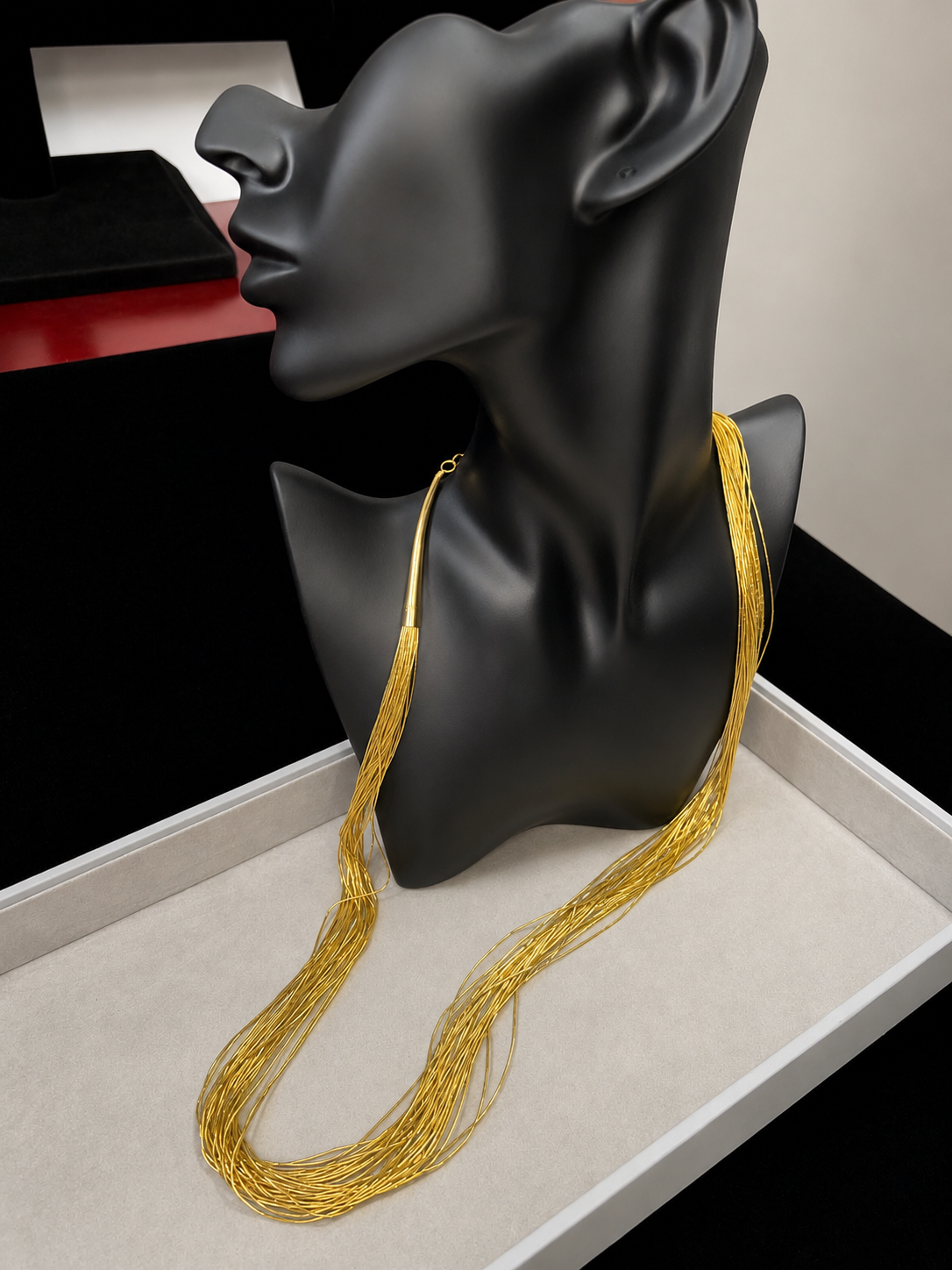 This is a striking gold over sterling silver necklace, featuring the iconic liquid-sterling design. The fluid, sculptural form creates visual movement and dimension, while the gold overlay adds warmth and luxury to the cool brilliance of sterling silver. With substantial length and thickness, this piece commands attention as a standalone statement.